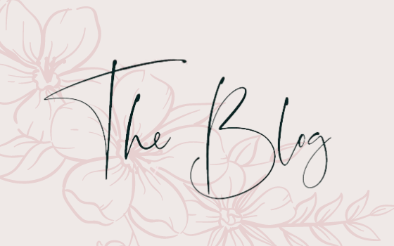 This image is the featured image for the Blog section of the Website. It is a light brown background with pink flowers and a script that says "The Blog"